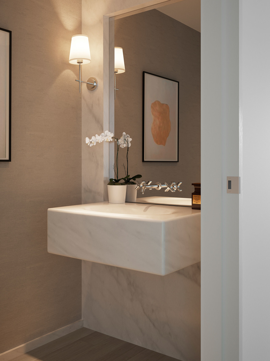 The powder room is intimate and beautifully appointed with a solid carved stone sink and feature wall of Bianco Dolomiti and a continuous solid wood floor. The design is both elegant and modern and leaves room for each owner to express his or her style.